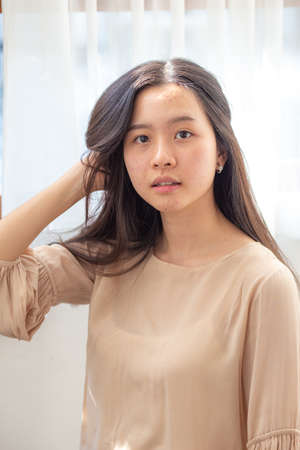 Portrait of beautiful sexy long hair women in cozy room pretty womenの写真素材