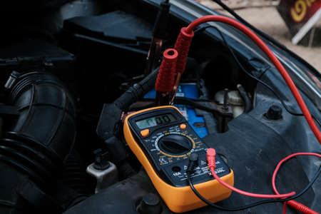 Battery car check with electric meter mechnic diagnosticの写真素材