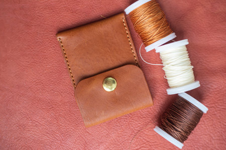 Handmade brown leather card holder craft working on leather background