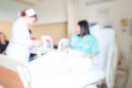 Blurred group of people visit patient in hospital healthy conceptの写真素材