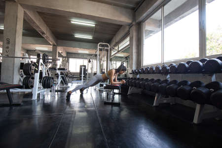 Sport women exercise in fitness gym muscular building wellbeing concept