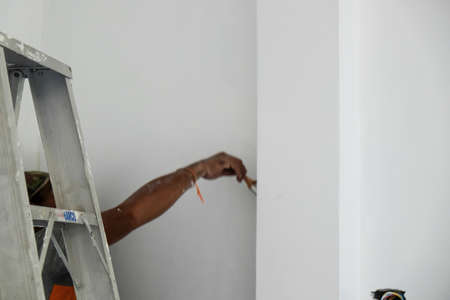 Mechanical man painting interior of modern hpuse building design conceptの写真素材