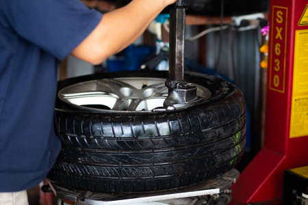 Car tire chang and check working in garage new tire