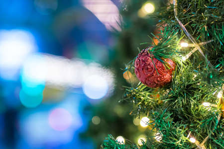 Red christmas ball and gift decoration on christmas tree night scene merry christmas