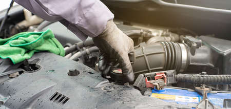 Mechanic man checking car engine radiator maintenance transport conceptの写真素材