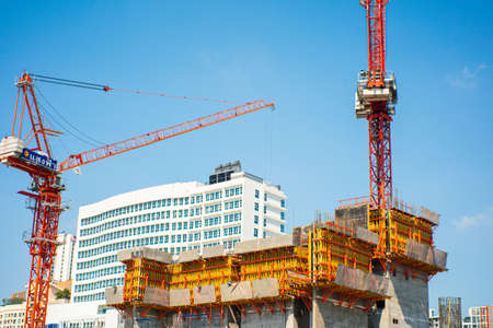 Construction site building with crane in modern city hi rise office building blue skyの写真素材