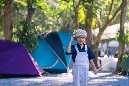 Happy little boy enjoying with adventure activity camping tent in green forest boy in natureの写真素材