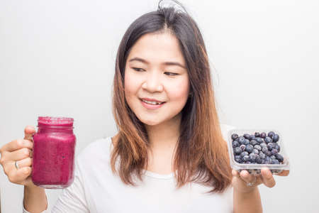Blueberry smoothy drink bottle with asian women summer drink on white backgroundの写真素材