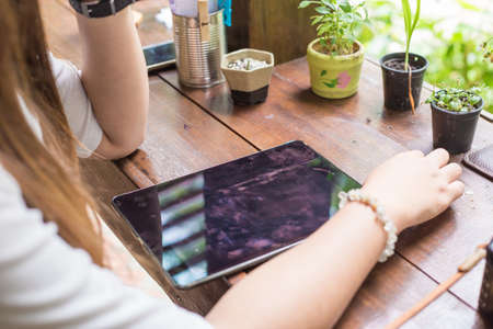 Beautiful asian women use tablet computer in coffee shop smiling business womenの写真素材
