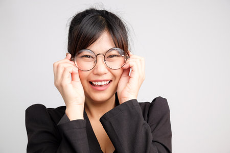 Beautiful attractive business asian women wear eyeglasses smiling on white background, Black suit business womenの写真素材