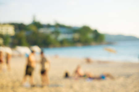 Abstract blurred people recreation on sea beach sunset summer vacation backgroundの写真素材