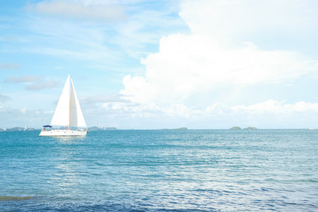 White sailboat on sea bay blue sky with cloud summer vacation backgroundの写真素材