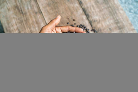 Roast coffee bean in hand on wood table aroma drink raw product