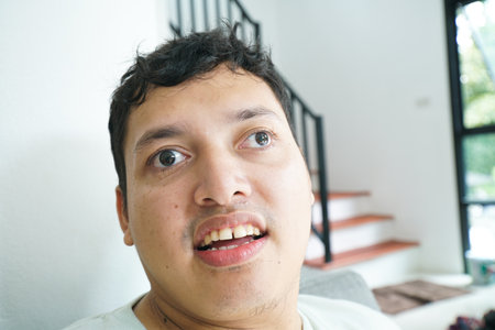Portrait of smiling asian handicapped man on white backgroundの写真素材