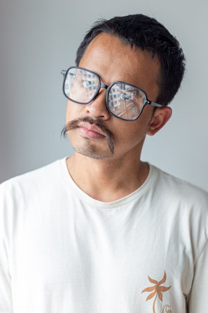 Artist mustache man facial face wear glasses angry motion on white backgroundの写真素材