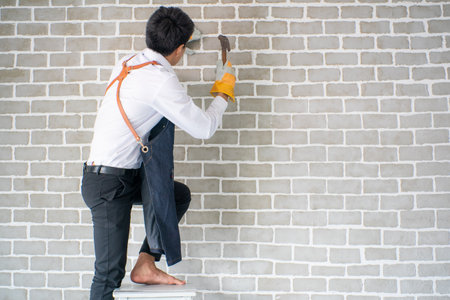 Interior house working and fix man working on wall of room decorate new designの写真素材