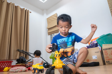 Boy and girl playing colourful toy in cozy room happy childrenの写真素材
