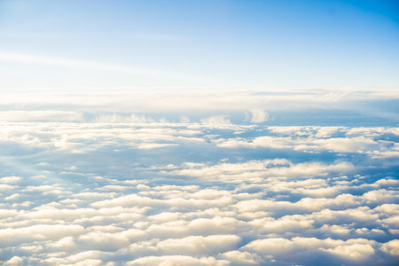 Cloudscape view from airplane window. Flying above the clouds at sunset.の写真素材