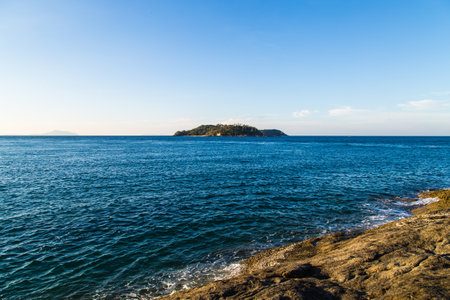 Sea wave splash on rocky beach sunny day morning sunrise Andaman seaの写真素材