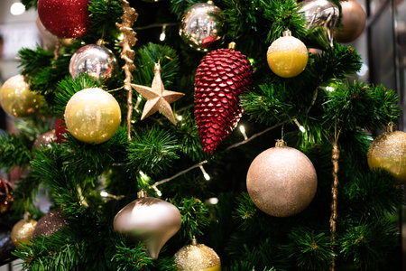 Christmas tree decorated with golden and silver ornaments, closeup