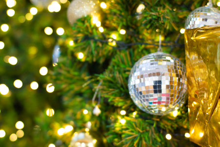 Christmass ball ornament on pine tree blurred bokeh background winter season merry x masの写真素材