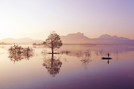 fisherman fishing in big lake ,thailand の写真素材