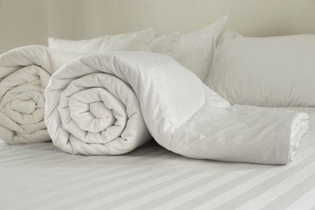 Duvet roll  down filled duvet rolled up isolated on white backgroundの写真素材