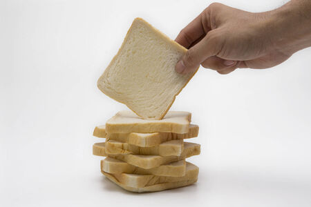 Hand hold a sliced bread isolated on white background