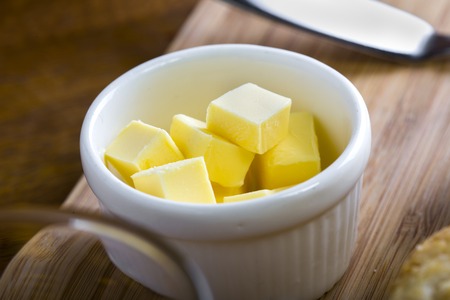 fresh yellow dairy butter in a white bowlの写真素材