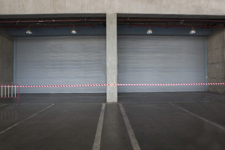 Shutter door inside factory night scene.の写真素材