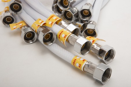 Steel water shower flexible hose isolated on whiteの写真素材