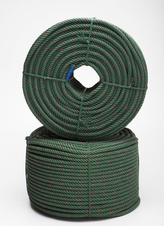 large roll with new green rope for the shipping industry