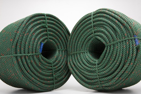 large roll with new green rope for the shipping industry