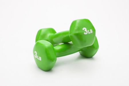 A pair of green rubber coated dumbbell isolated on white background.の写真素材