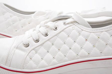 Pair of new white sneakers on white backgroundの写真素材