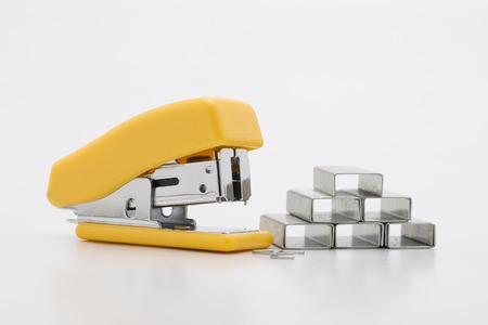 Stapler with staples yellow lines on a white background.
