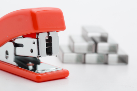 Stapler with staples yellow lines on a white background.