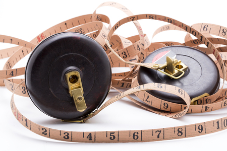 Old tape measure on white backgroundの写真素材