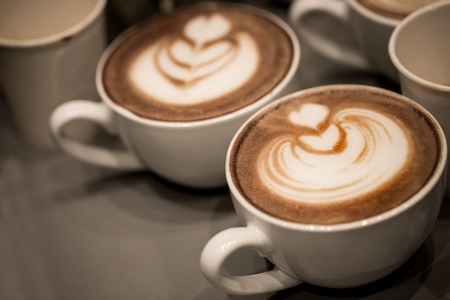 Cup of art latte on a cappuccino coffeeの写真素材