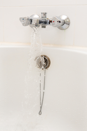 Luxury bath tub and faucet with water.の写真素材