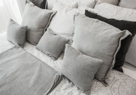 Stylish bedroom with black pillow on the bed.の写真素材