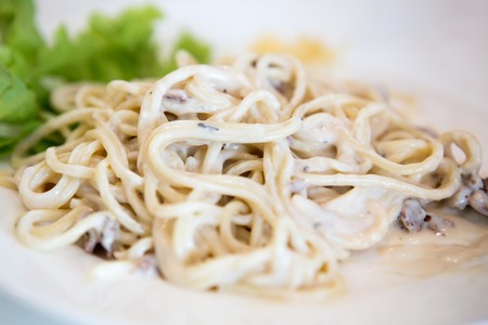 Kids are eating delicious spaghetti.の写真素材