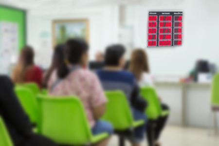 People sitting in queues in the office.の写真素材