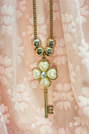 A diamond shaped pendant in the background is a beautiful fabric.の写真素材