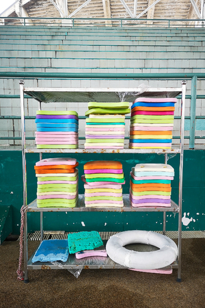 Stack of the colourful swim boards in the swimming pool.