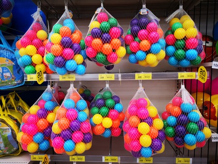Children play colorful plastic balls in the net.
