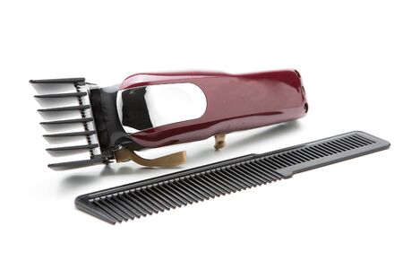 Red clippers for cutting hair on a white background