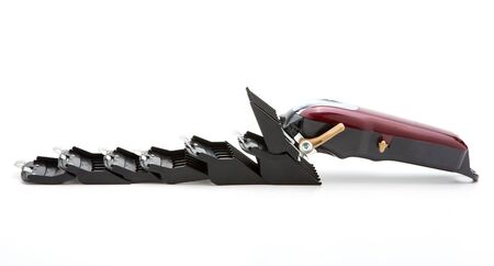 Clippers and accessories for cutting hair on a white background