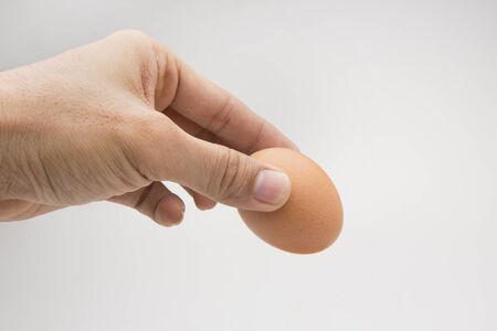 Single brown chicken egg isolated on whiteの写真素材