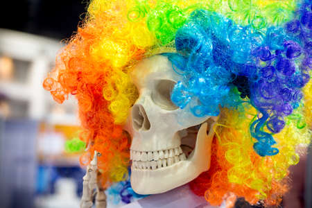 A skull wearing a wig, colorful and funny.の写真素材